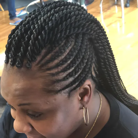 Client with cornrows braided into a stylish twist at Uniq Braiding Salon.