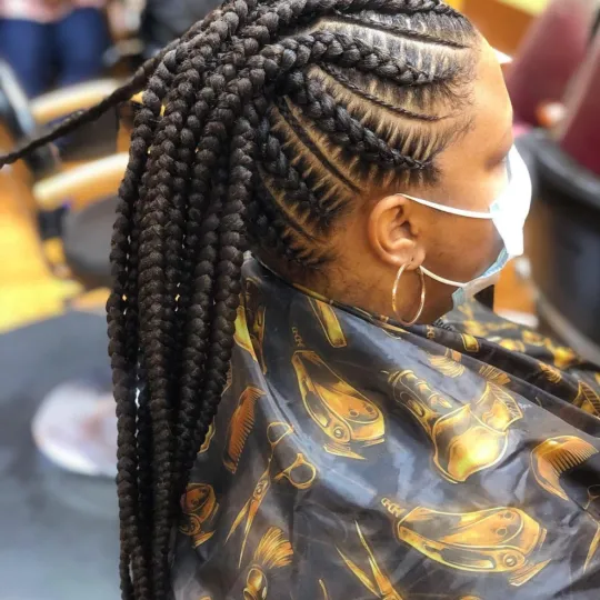 Client with high ponytail stitch braids at Uniq Braiding Salon.