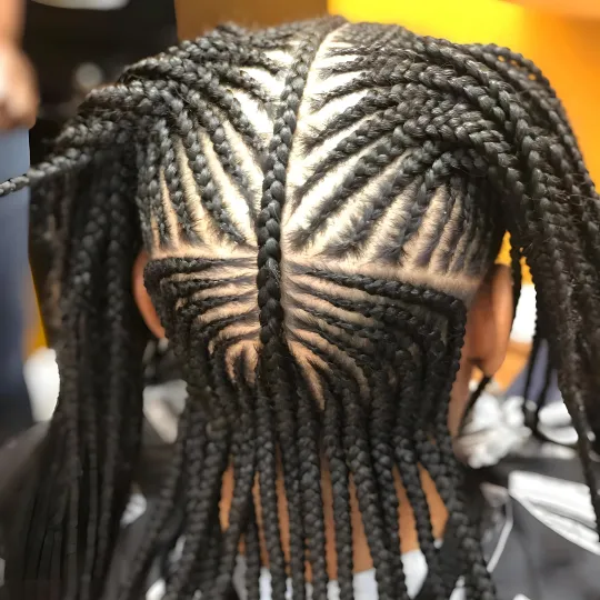 Back view of a child's hair with intricate cornrow braids at Uniq Braiding Salon.