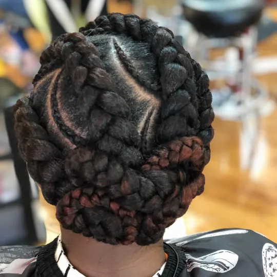 Client with intricate updo stitch braids at Uniq Braiding Salon