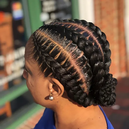 Client with intricate cornrows braided into a low bun at Uniq Braiding Salon.