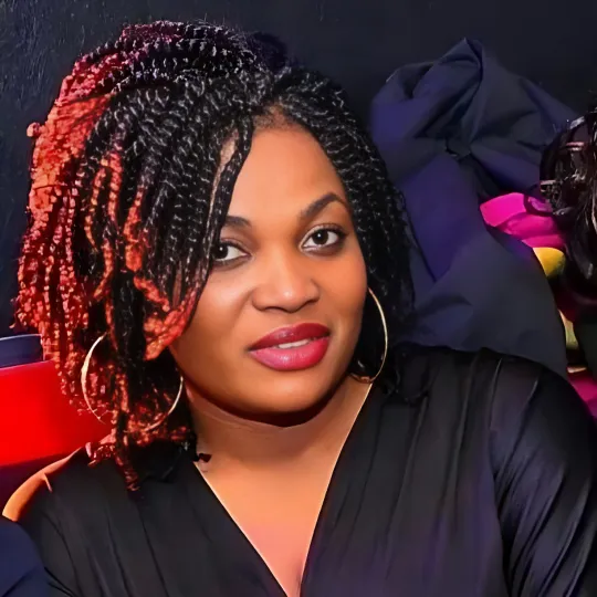 Client with short spring twists in a stylish and vibrant look at Uniq Hair Braiding Salon.